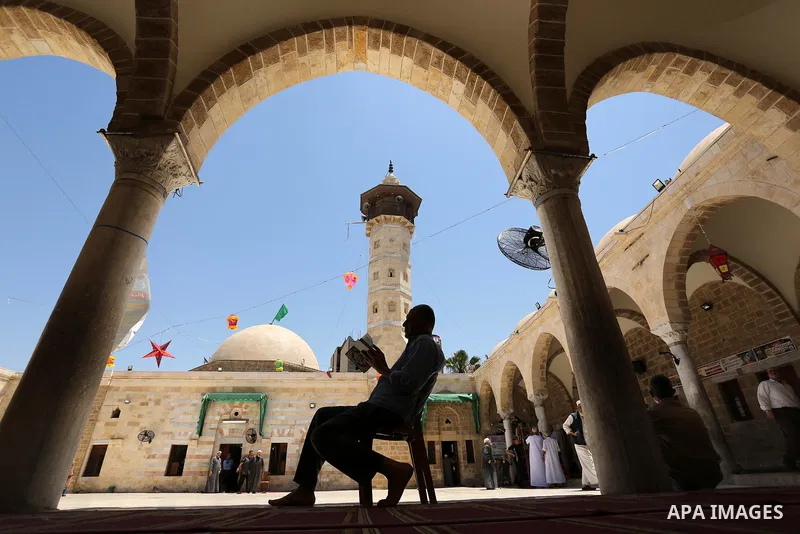 A Palestinian man reads a copy of the Koran, Islam's holiest book, on the Muslim holy fasting month of Ramadan at the al- Sayed Hashim mosque in Gaza city on May 29, 2017. Ramadan is sacred to Muslims because it is durin...
