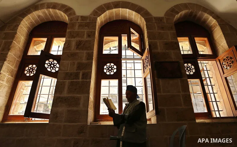 A Palestinian man reads a copy of the Koran, Islam's holiest book, on the Muslim holy fasting month of Ramadan at the al- Sayed Hashim mosque in Gaza city on May 29, 2017. Ramadan is sacred to Muslims because it is durin...