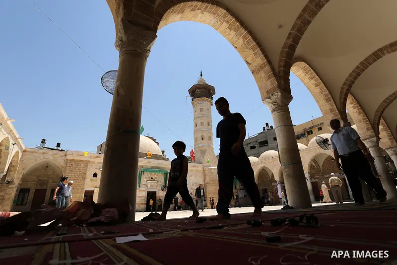 Palestinians walk after prayer at the al- Sayed Hashim mosque on the Muslim holy fasting month of Ramadan in Gaza city on May 29, 2017. Ramadan is sacred to Muslims because it is during that month that tradition says the...