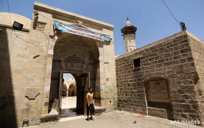 A Palestinian youth stand outside al- Sayed Hashim mosque on the Muslim holy fasting month of Ramadan in Gaza city on May 29, 2017. Ramadan is sacred to Muslims because it is during that month that tradition says the Kor...