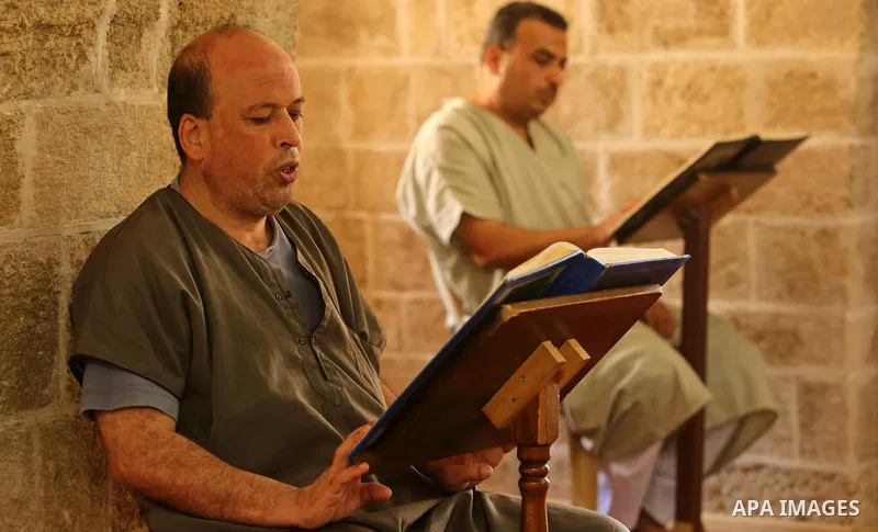Palestinian men read copies of the Koran, Islam's holiest book, on the Muslim holy fasting month of Ramadan at the al- Sayed Hashim mosque in Gaza city on May 29, 2017. Ramadan is sacred to Muslims because it is during t...