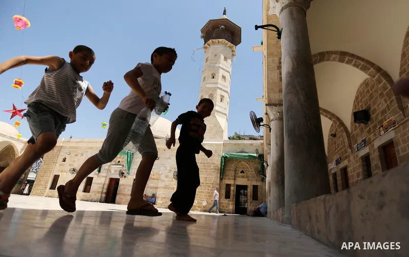 Palestinian boys run after prayer at the al- Sayed Hashim mosque on the Muslim holy fasting month of Ramadan in Gaza city on May 29, 2017. Ramadan is sacred to Muslims because it is during that month that tradition says...