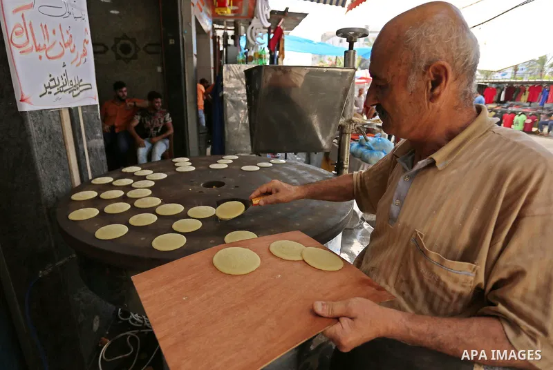 A Palestinian vendor prepares traditional pancakes known as ''Qatayef'' on the Muslim holy fasting month of Ramadan at market in Gaza city on May 29, 2017. Ramadan is sacred to Muslims because it is during that month tha...