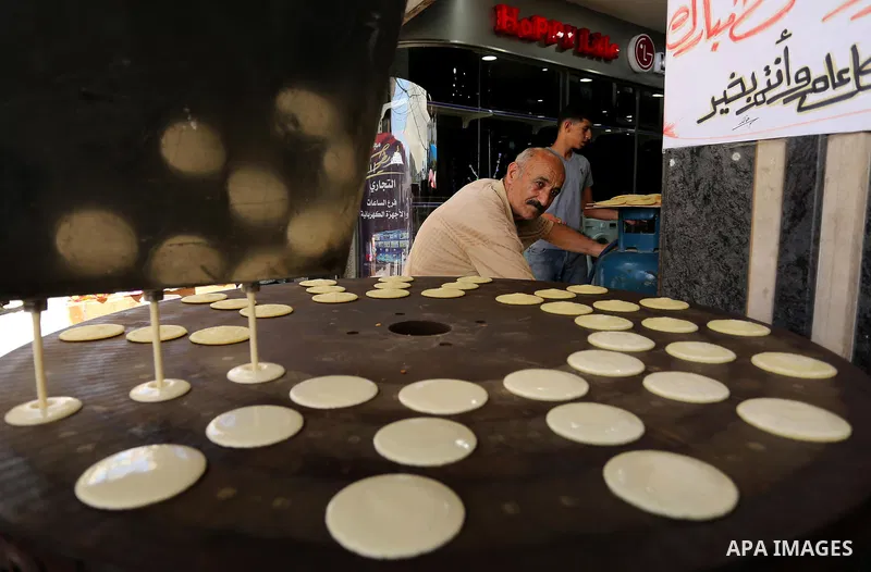A Palestinian vendor prepares traditional pancakes known as ''Qatayef'' on the Muslim holy fasting month of Ramadan at market in Gaza city on May 29, 2017. Ramadan is sacred to Muslims because it is during that month tha...
