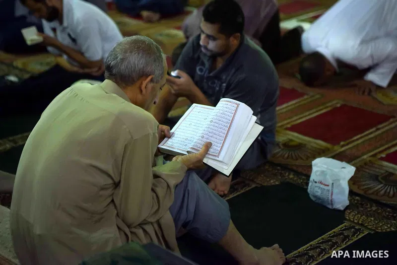 An Egyptian man reads a copy of the Koran, Islam's holiest book, on the Muslim holy fasting month of Ramadan at Amr Ibn al-Aas mosque, in Cairo on May 30, 2017. Ramadan is sacred to Muslims because it is during that mont...
