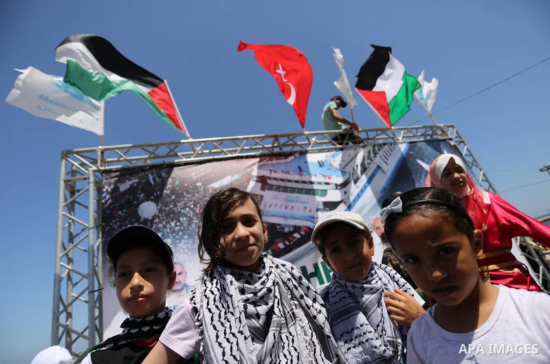 Palestinian children hold the Palestinian and Turkish flags during a rally to mark the 7th anniversary of the Mavi Marmara Gaza flotilla incident, at the seaport of Gaza City May 31, 2017. Nine activists, eight Turkish a...