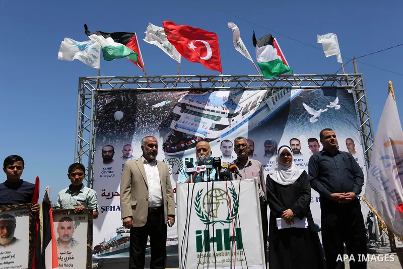 Palestinian children hold the Palestinian and Turkish flags and picture of activists who was dead by Israeli forces during a rally to mark the 7th anniversary of the Mavi Marmara Gaza flotilla incident, at the seaport of...