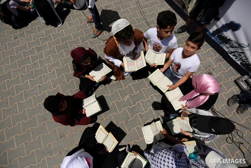 Palestinian children read copies of Koran during a rally to mark the 7th anniversary of the Mavi Marmara Gaza flotilla incident, at the seaport of Gaza City May 31, 2017. Nine activists, eight Turkish and one Turkish-Ame...