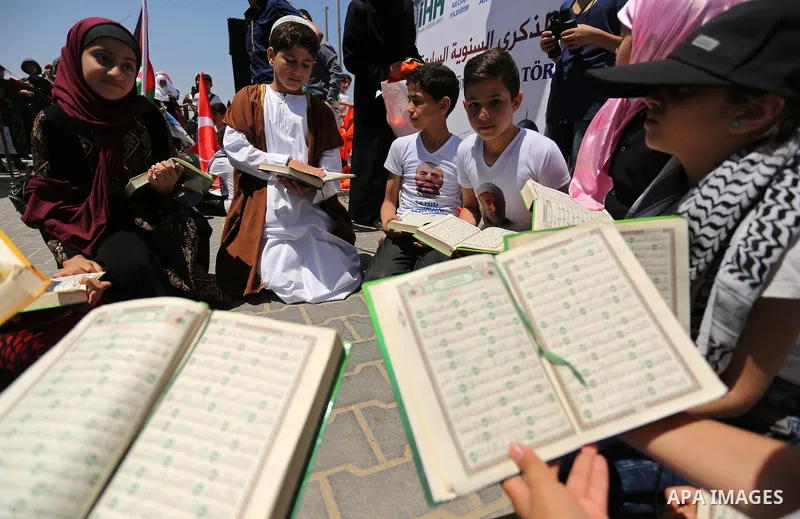 Palestinian children read copies of Koran during a rally to mark the 7th anniversary of the Mavi Marmara Gaza flotilla incident, at the seaport of Gaza City May 31, 2017. Nine activists, eight Turkish and one Turkish-Ame...