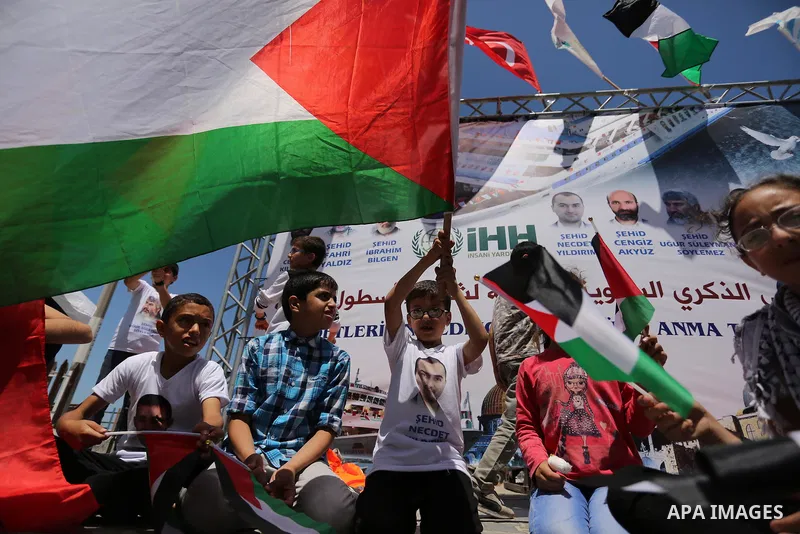 Palestinian children hold the Palestinian and Turkish flags during a rally to mark the 7th anniversary of the Mavi Marmara Gaza flotilla incident, at the seaport of Gaza City May 31, 2017. Nine activists, eight Turkish a...