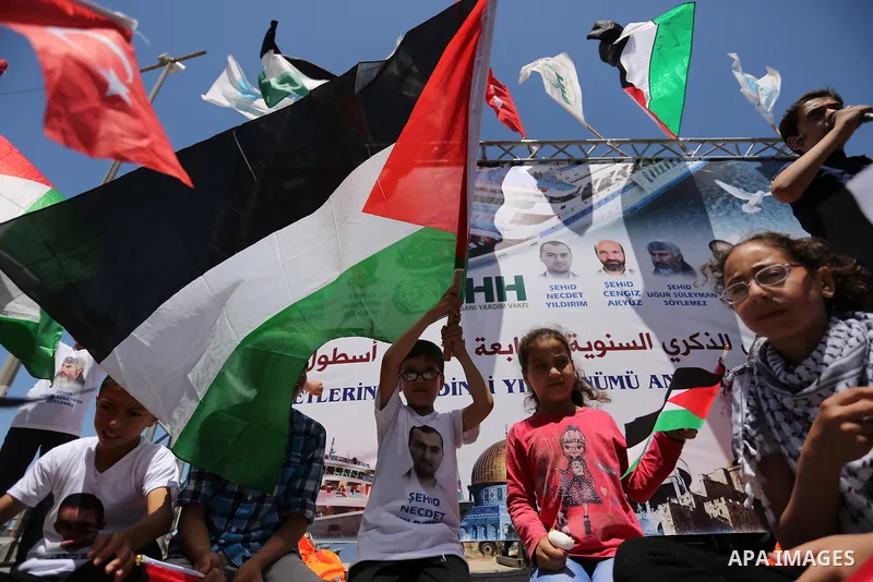 Palestinian children hold the Palestinian and Turkish flags during a rally to mark the 7th anniversary of the Mavi Marmara Gaza flotilla incident, at the seaport of Gaza City May 31, 2017. Nine activists, eight Turkish a...