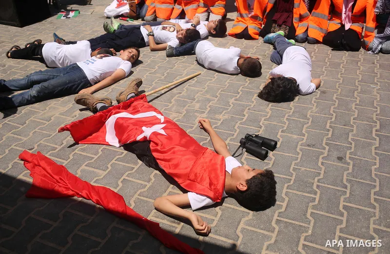 Palestinian children take part during a rally to mark the 7th anniversary of the Mavi Marmara Gaza flotilla incident, as they simulate the raided of Israeli commandos to Mavi Marmara ship, at the seaport of Gaza City May...