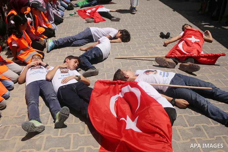 Palestinian children take part during a rally to mark the 7th anniversary of the Mavi Marmara Gaza flotilla incident, as they simulate the raided of Israeli commandos to Mavi Marmara ship, at the seaport of Gaza City May...