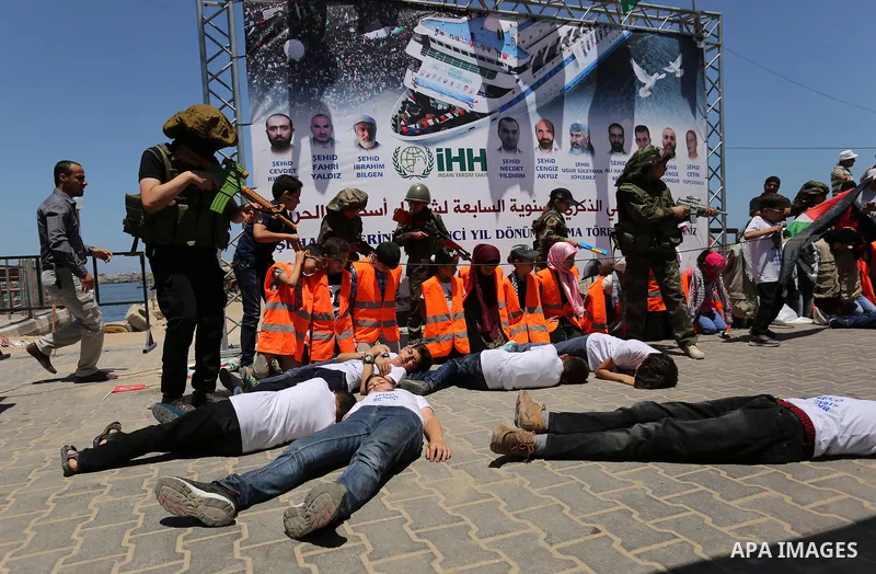 Palestinian children take part during a rally to mark the 7th anniversary of the Mavi Marmara Gaza flotilla incident, as they simulate the raided of Israeli commandos to Mavi Marmara ship, at the seaport of Gaza City May...