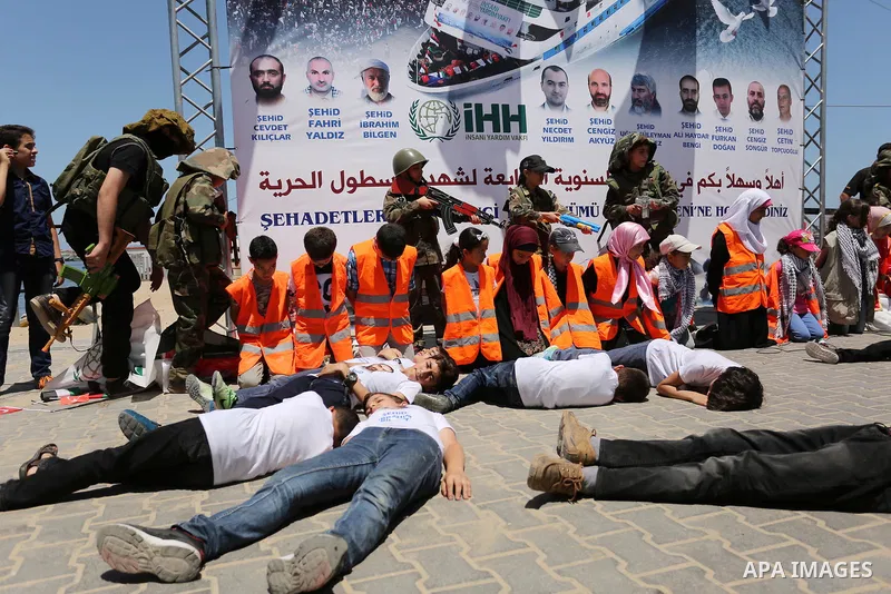 Palestinian children take part during a rally to mark the 7th anniversary of the Mavi Marmara Gaza flotilla incident, as they simulate the raided of Israeli commandos to Mavi Marmara ship, at the seaport of Gaza City May...