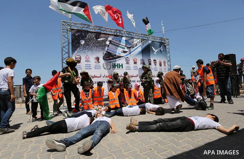 Palestinian children take part during a rally to mark the 7th anniversary of the Mavi Marmara Gaza flotilla incident, as they simulate the raided of Israeli commandos to Mavi Marmara ship, at the seaport of Gaza City May...