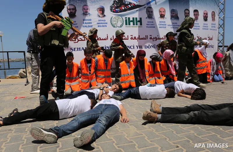 Palestinian children take part during a rally to mark the 7th anniversary of the Mavi Marmara Gaza flotilla incident, as they simulate the raided of Israeli commandos to Mavi Marmara ship, at the seaport of Gaza City May...