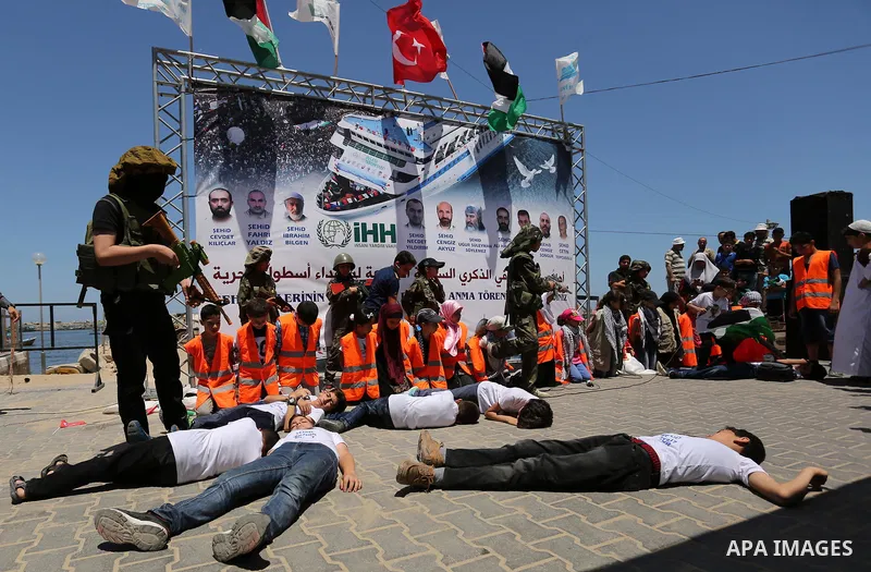 Palestinian children take part during a rally to mark the 7th anniversary of the Mavi Marmara Gaza flotilla incident, as they simulate the raided of Israeli commandos to Mavi Marmara ship, at the seaport of Gaza City May...