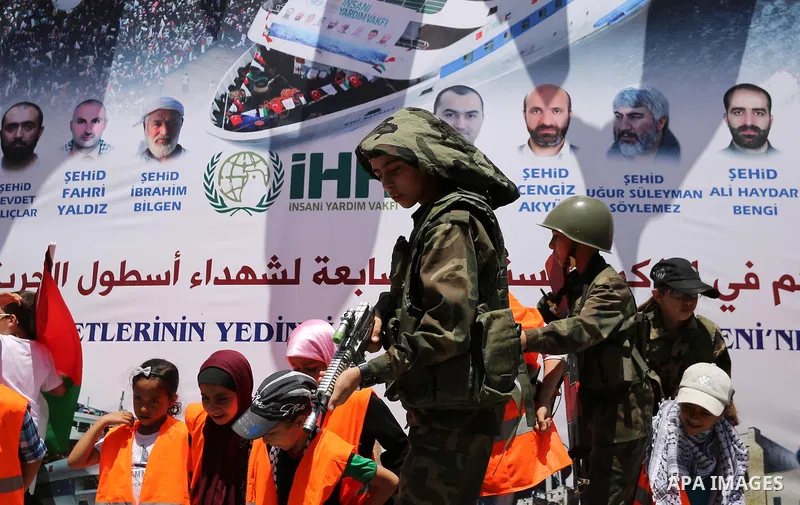 Palestinian children take part during a rally to mark the 7th anniversary of the Mavi Marmara Gaza flotilla incident, as they simulate the raided of Israeli commandos to Mavi Marmara ship, at the seaport of Gaza City May...