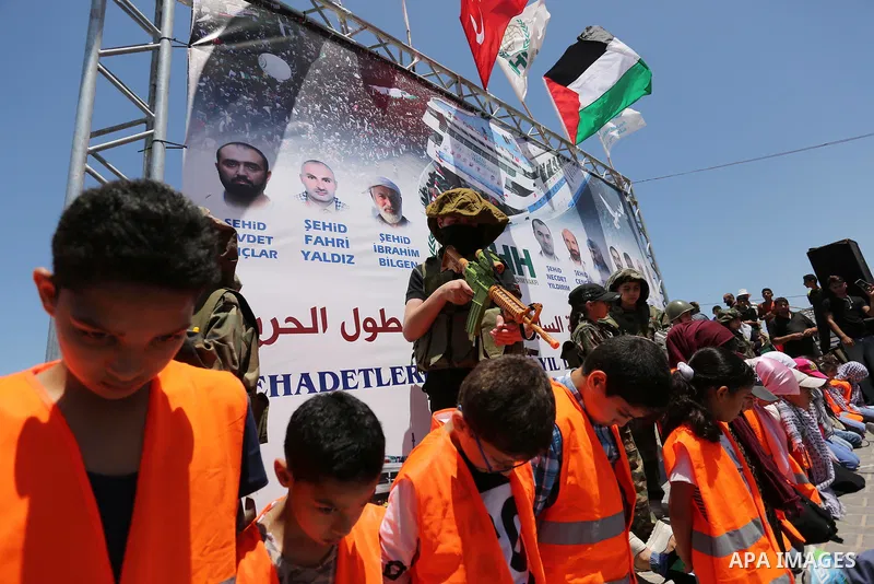 Palestinian children take part during a rally to mark the 7th anniversary of the Mavi Marmara Gaza flotilla incident, as they simulate the raided of Israeli commandos to Mavi Marmara ship, at the seaport of Gaza City May...