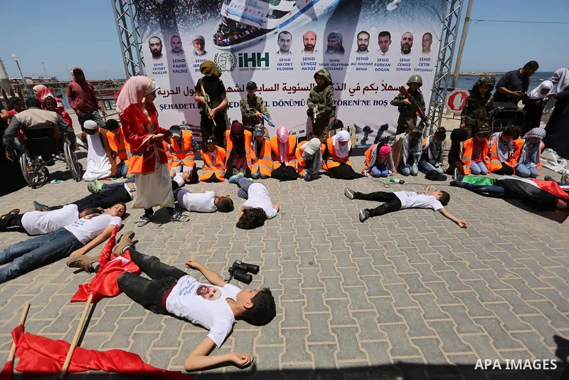 Palestinian children take part during a rally to mark the 7th anniversary of the Mavi Marmara Gaza flotilla incident, as they simulate the raided of Israeli commandos to Mavi Marmara ship, at the seaport of Gaza City May...