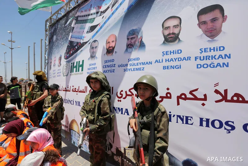 Palestinian children take part during a rally to mark the 7th anniversary of the Mavi Marmara Gaza flotilla incident, as they simulate the raided of Israeli commandos to Mavi Marmara ship, at the seaport of Gaza City May...