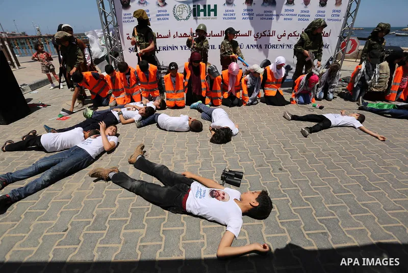 Palestinian children take part during a rally to mark the 7th anniversary of the Mavi Marmara Gaza flotilla incident, as they simulate the raided of Israeli commandos to Mavi Marmara ship, at the seaport of Gaza City May...