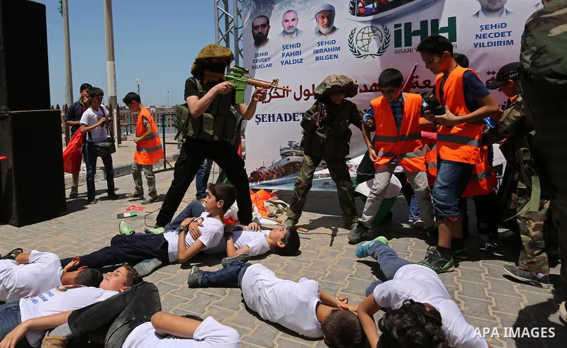 Palestinian children take part during a rally to mark the 7th anniversary of the Mavi Marmara Gaza flotilla incident, as they simulate the raided of Israeli commandos to Mavi Marmara ship, at the seaport of Gaza City May...
