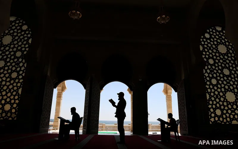 Palestinians read a copy of the Koran, Islam's holiest book, on the Muslim holy fasting month of Ramadan at al-Khaldi mosque in Gaza city on May 31, 2017. Ramadan is sacred to Muslims because it is during that month that...