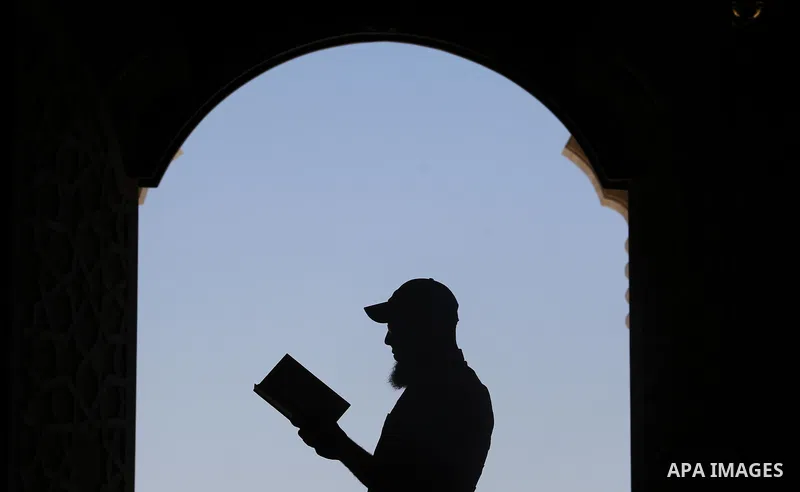 A Palestinian man reads a copy of the Koran, Islam's holiest book, on the Muslim holy fasting month of Ramadan at al-Khaldi mosque in Gaza city on May 31, 2017. Ramadan is sacred to Muslims because it is during that mont...