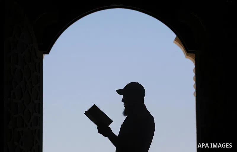 A Palestinian man reads a copy of the Koran, Islam's holiest book, on the Muslim holy fasting month of Ramadan at al-Khaldi mosque in Gaza city on May 31, 2017. Ramadan is sacred to Muslims because it is during that mont...