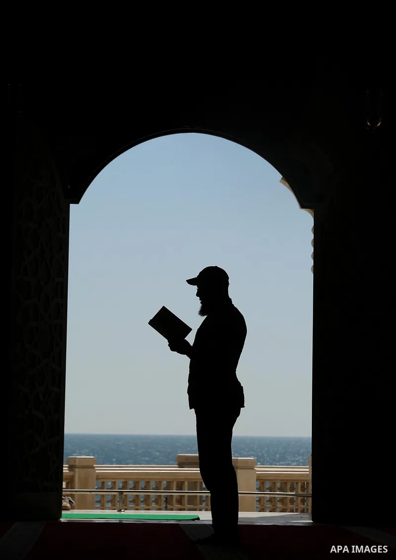 A Palestinian man reads a copy of the Koran, Islam's holiest book, on the Muslim holy fasting month of Ramadan at al-Khaldi mosque in Gaza city on May 31, 2017. Ramadan is sacred to Muslims because it is during that mont...
