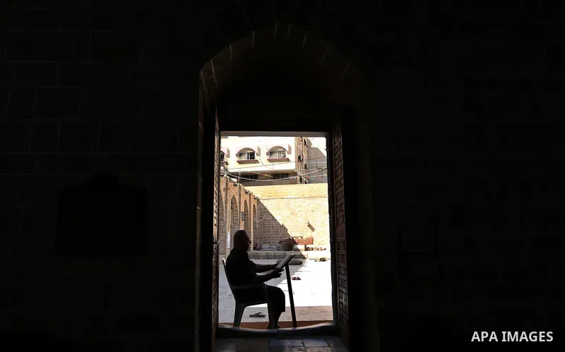 A Palestinian man reads a copy of the Koran, Islam's holiest book, on the Muslim holy fasting month of Ramadan at the al-Omari mosque in Gaza city on May 31, 2017. Ramadan is sacred to Muslims because it is during that m...