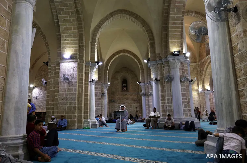 Palestinians read a copy of the Koran, Islam's holiest book, on the Muslim holy fasting month of Ramadan at the al-Omari mosque in Gaza city on May 31, 2017. Ramadan is sacred to Muslims because it is during that month t...