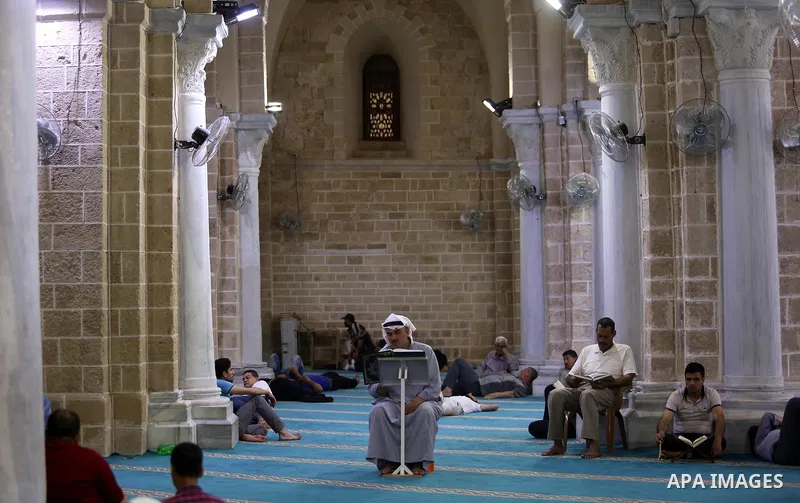 Palestinians read a copy of the Koran, Islam's holiest book, on the Muslim holy fasting month of Ramadan at the al-Omari mosque in Gaza city on May 31, 2017. Ramadan is sacred to Muslims because it is during that month t...