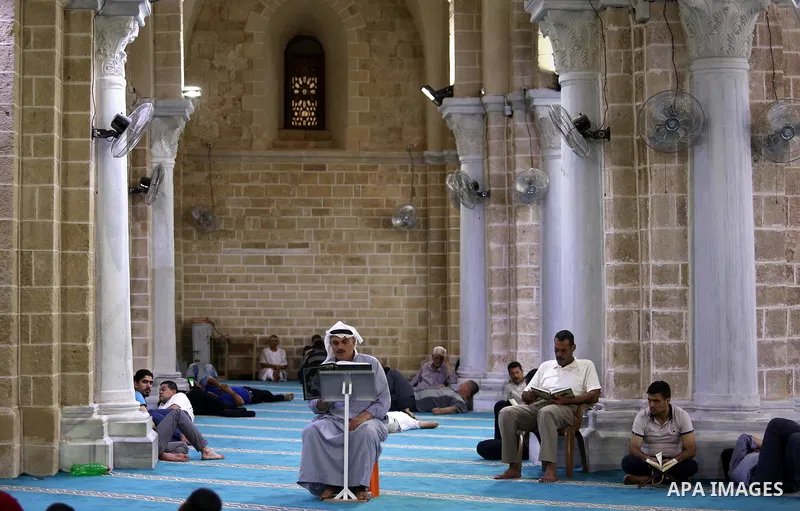 Palestinians read a copy of the Koran, Islam's holiest book, on the Muslim holy fasting month of Ramadan at the al-Omari mosque in Gaza city on May 31, 2017. Ramadan is sacred to Muslims because it is during that month t...