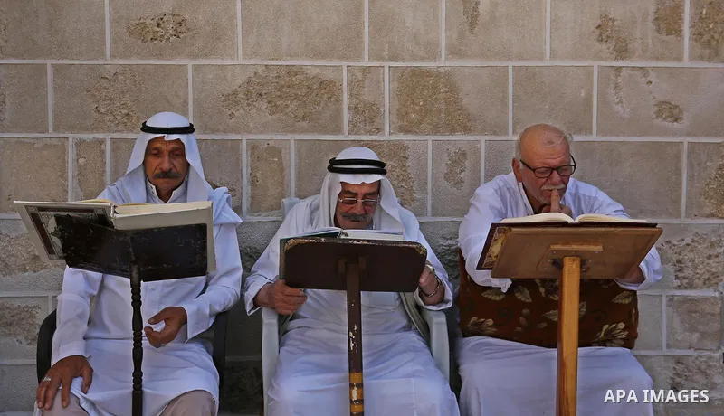 Palestinians read a copy of the Koran, Islam's holiest book, on the Muslim holy fasting month of Ramadan at the al-Omari mosque in Gaza city on May 31, 2017. Ramadan is sacred to Muslims because it is during that month t...