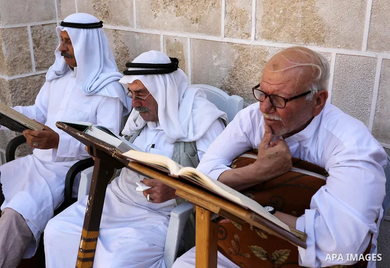 Palestinians read a copy of the Koran, Islam's holiest book, on the Muslim holy fasting month of Ramadan at the al-Omari mosque in Gaza city on May 31, 2017. Ramadan is sacred to Muslims because it is during that month t...