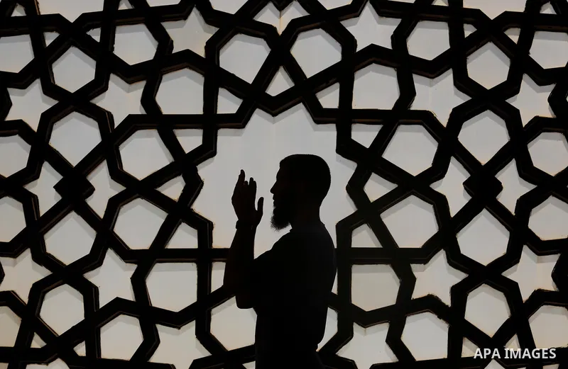 A Palestinian man reads a copy of the Koran, Islam's holiest book, on the Muslim holy fasting month of Ramadan at al-Khaldi mosque in Gaza city on May 31, 2017. Ramadan is sacred to Muslims because it is during that mont...