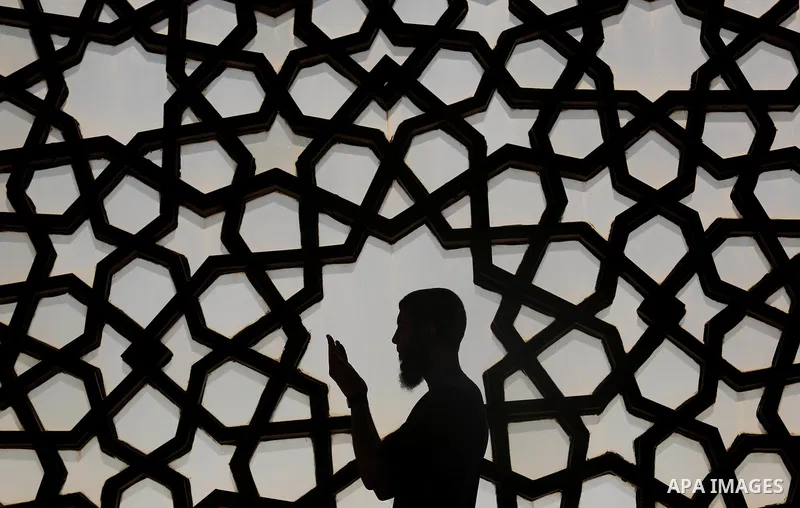 A Palestinian man reads a copy of the Koran, Islam's holiest book, on the Muslim holy fasting month of Ramadan at al-Khaldi mosque in Gaza city on May 31, 2017. Ramadan is sacred to Muslims because it is during that mont...