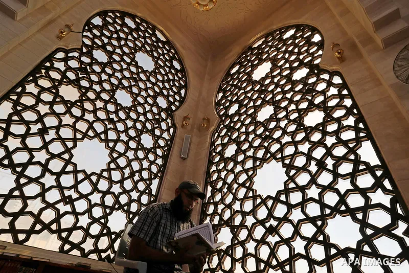 A Palestinian man reads a copy of the Koran, Islam's holiest book, on the Muslim holy fasting month of Ramadan at al-Khaldi mosque in Gaza city on May 31, 2017. Ramadan is sacred to Muslims because it is during that mont...