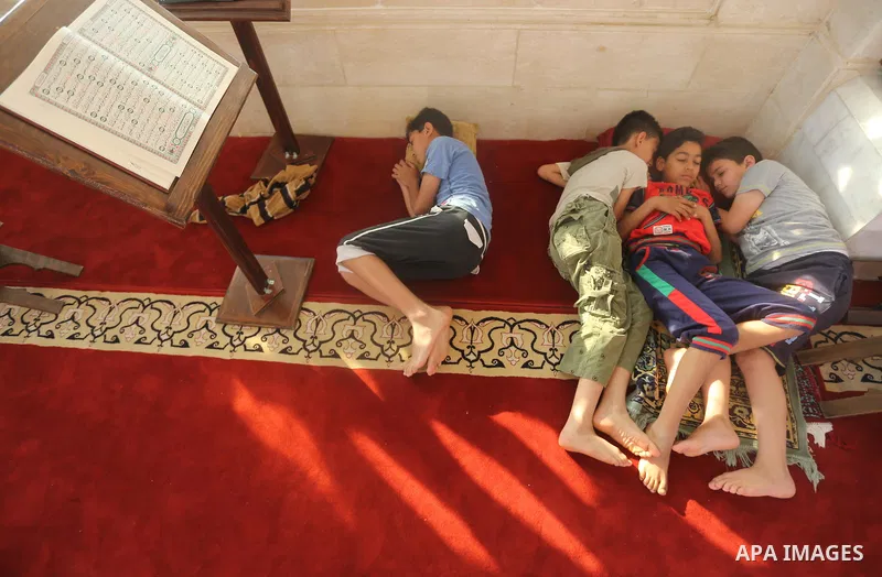 Palestinian boys take nap, on the Muslim holy fasting month of Ramadan at al-Khaldi mosque in Gaza city on May 31, 2017. Ramadan is sacred to Muslims because it is during that month that tradition says the Koran was reve...