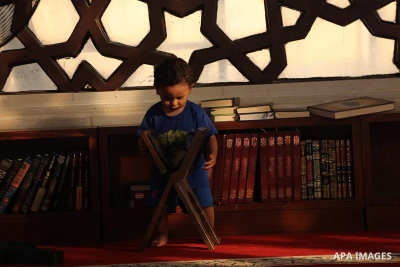 A Palestinian boy reads a copy of the Koran, Islam's holiest book, on the Muslim holy fasting month of Ramadan at al-Khaldi mosque in Gaza city on May 31, 2017. Ramadan is sacred to Muslims because it is during that mont...