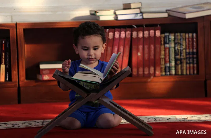 A Palestinian boy reads a copy of the Koran, Islam's holiest book, on the Muslim holy fasting month of Ramadan at al-Khaldi mosque in Gaza city on May 31, 2017. Ramadan is sacred to Muslims because it is during that mont...