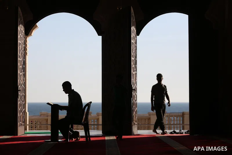 A Palestinian man reads a copy of the Koran, Islam's holiest book, on the Muslim holy fasting month of Ramadan at al-Khaldi mosque in Gaza city on May 31, 2017. Ramadan is sacred to Muslims because it is during that mont...