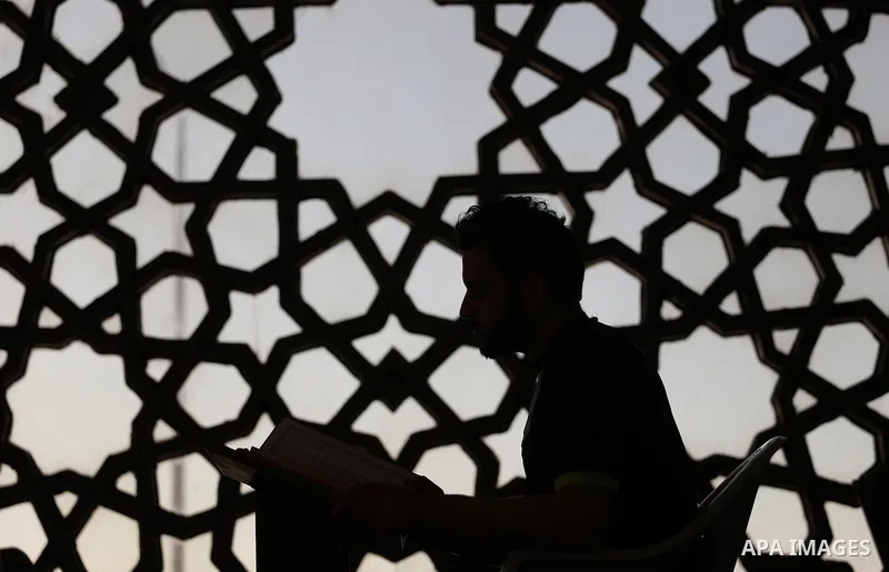 A Palestinian boy reads a copy of the Koran, Islam's holiest book, on the Muslim holy fasting month of Ramadan at al-Khaldi mosque in Gaza city on May 31, 2017. Ramadan is sacred to Muslims because it is during that mont...