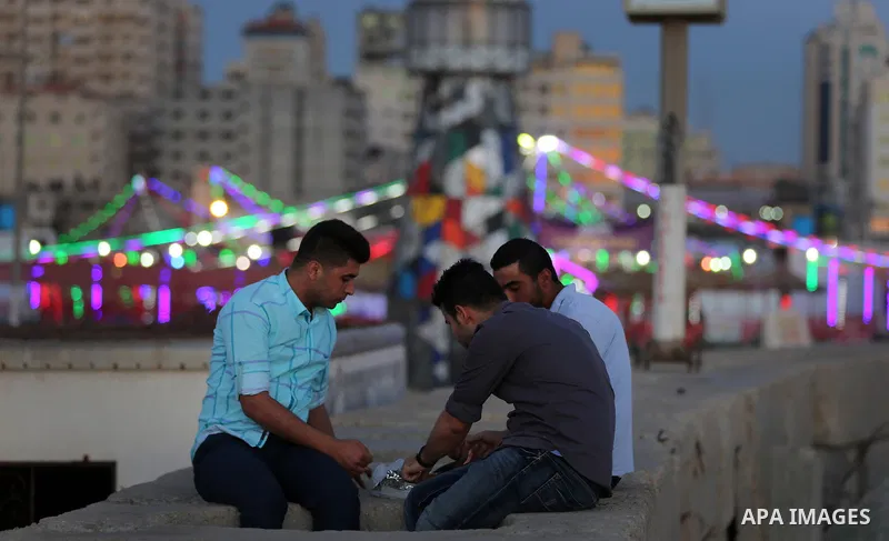 A Palestinian family gathers at the beach, during power cuts, to break their fast in Gaza City on May 31, 2017, during the Muslim Holy month of Ramadan. Ramadan is sacred to Muslims because it is during that month that t...