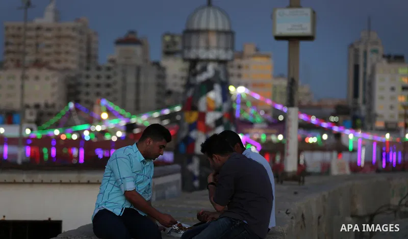 A Palestinian family gathers at the beach, during power cuts, to break their fast in Gaza City on May 31, 2017, during the Muslim Holy month of Ramadan. Ramadan is sacred to Muslims because it is during that month that t...