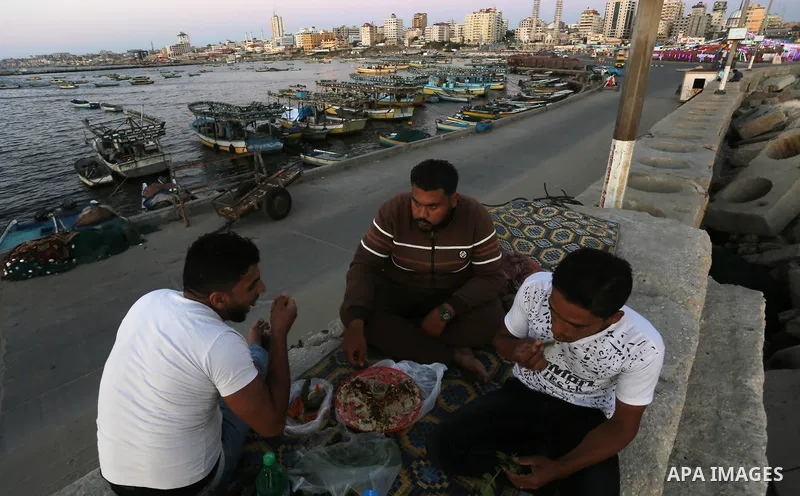 A Palestinian family gathers at the beach, during power cuts, to break their fast in Gaza City on May 31, 2017, during the Muslim Holy month of Ramadan. Ramadan is sacred to Muslims because it is during that month that t...