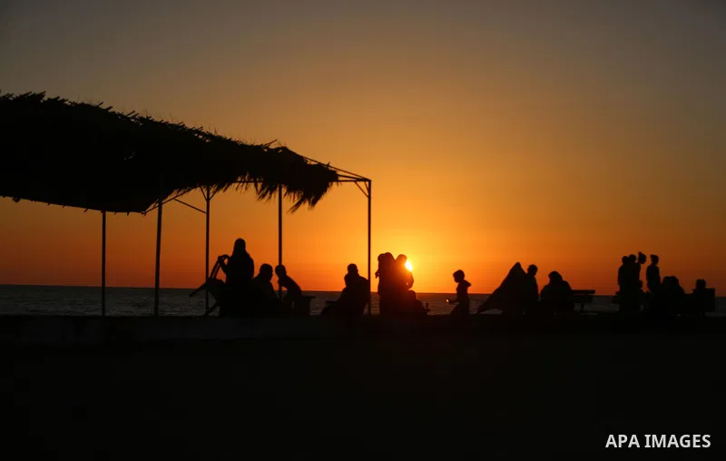 A Palestinian family gathers at the beach, during power cuts, to break their fast in Gaza City on May 31, 2017, during the Muslim Holy month of Ramadan. Ramadan is sacred to Muslims because it is during that month that t...